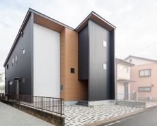 大型収納のあるガルバリウム鋼板と木目のシンプルモダンな家